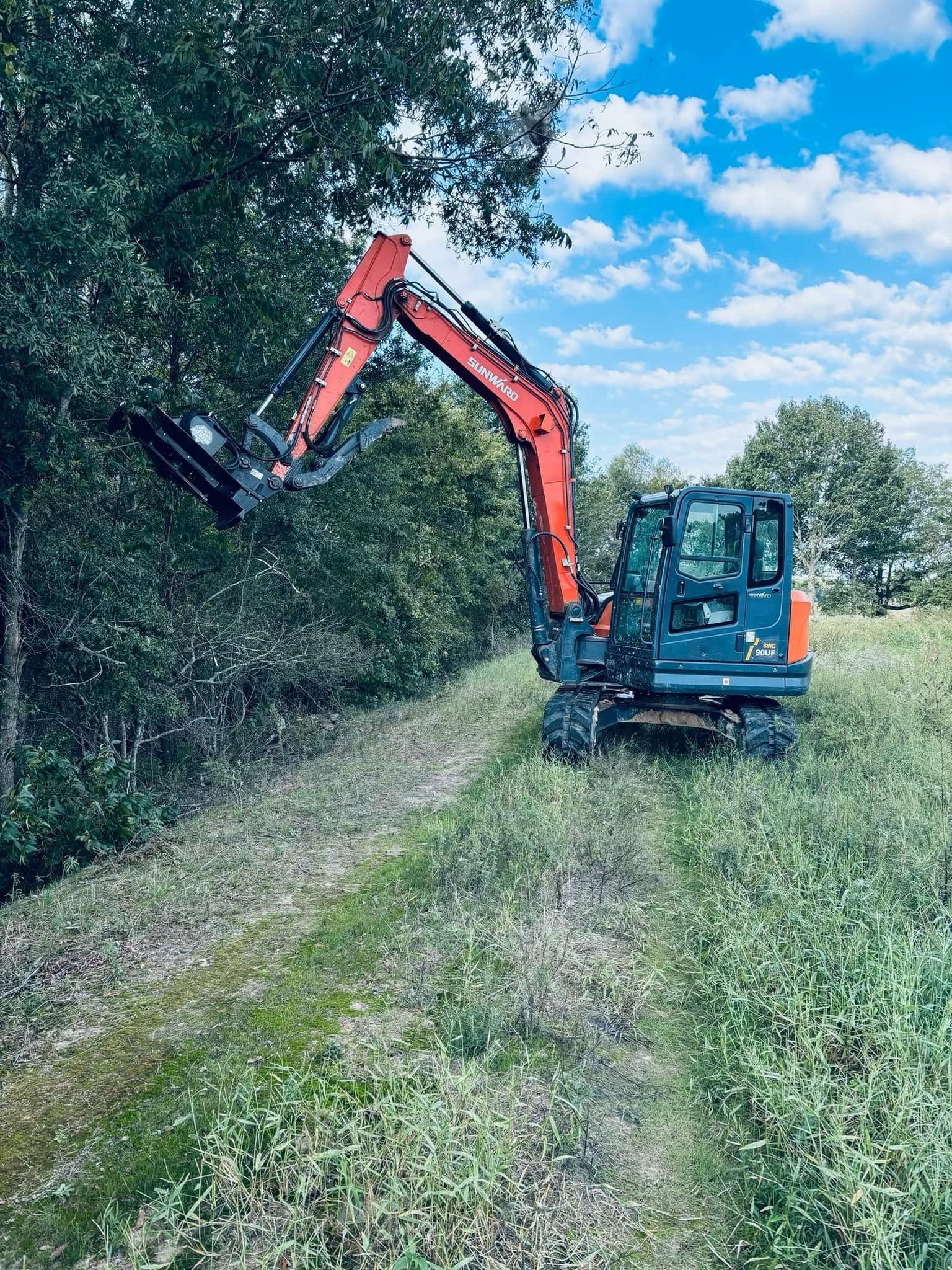 Sunward mini excavator mulching a tree line