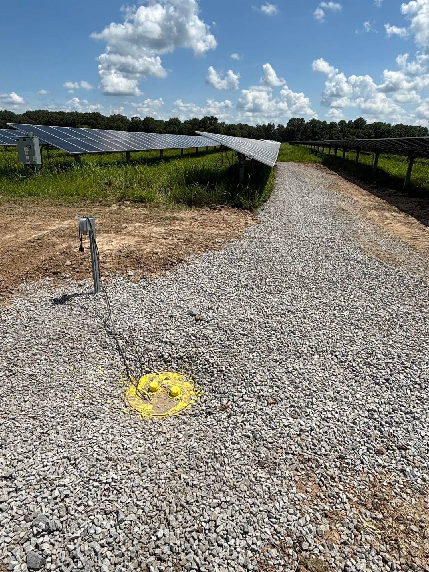 Wide gravel access road cut for a commercial site