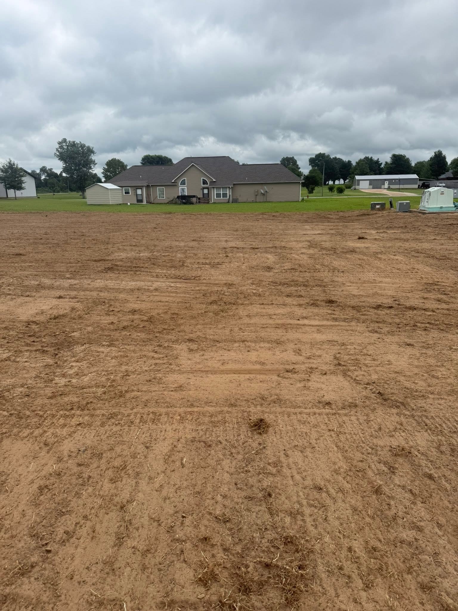 Gravel and dirt work job — large lot graded and prepped behind a home